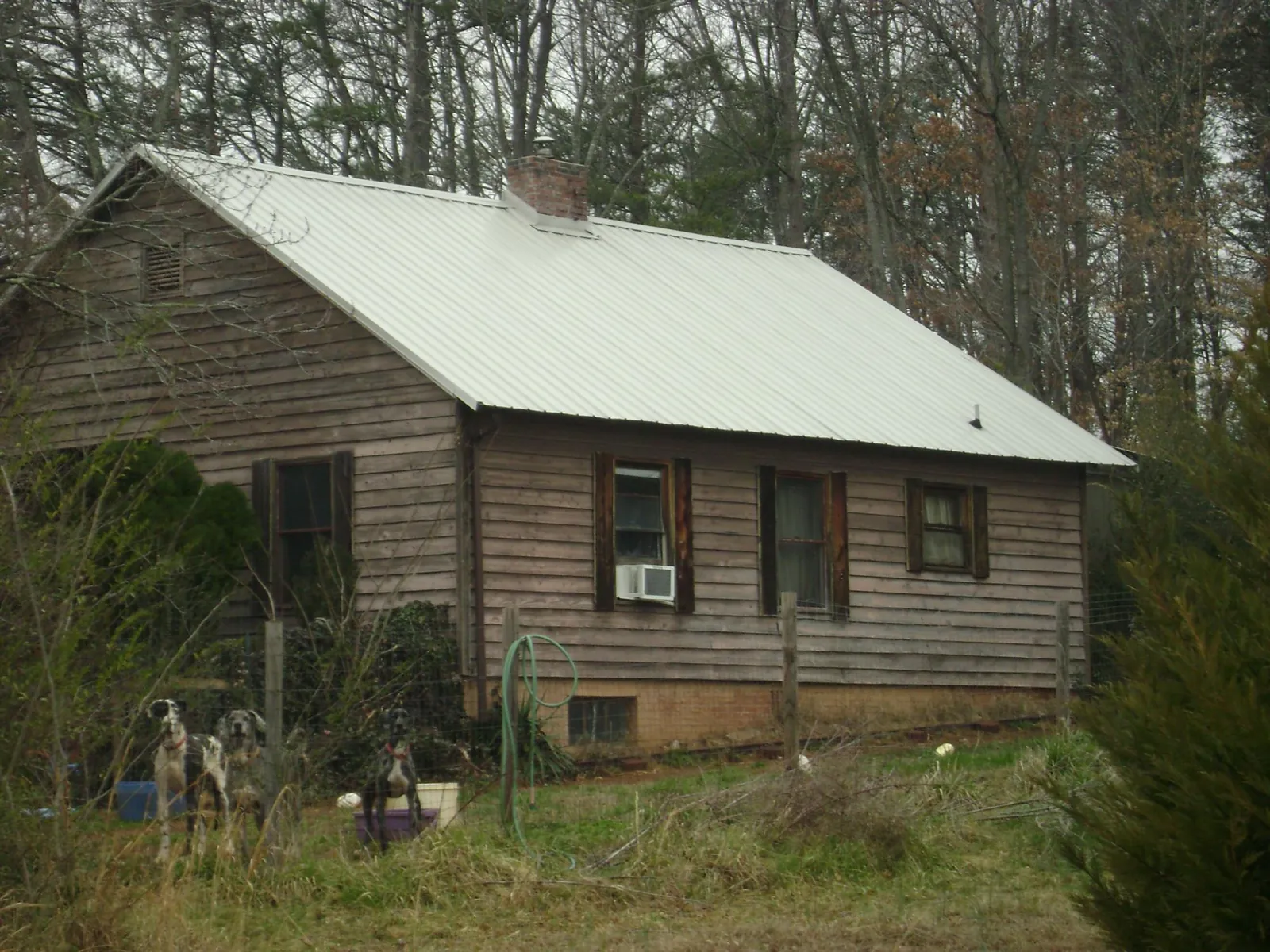 White metal roof on an old wood sided farmhouse, from a Metal Roof Installation job in Mountville